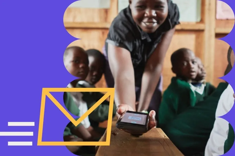 Smiling teacher handing a phone to pupils, next to an envelope icon